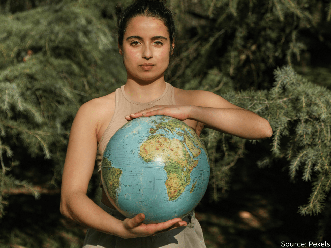 woman holding model of globe in her hands